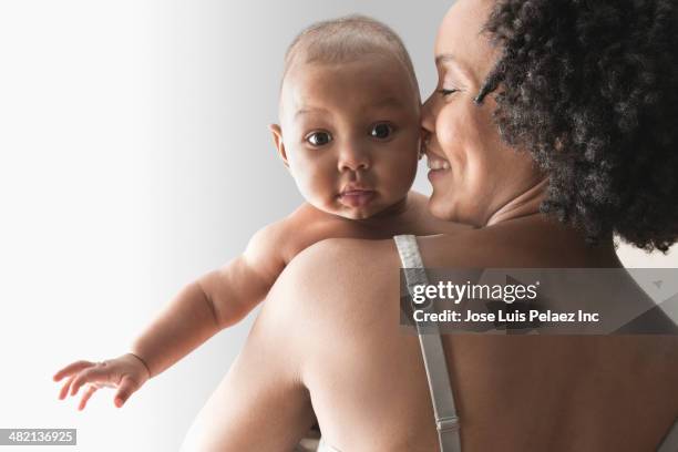 mother holding baby indoors - girls in bras bildbanksfoton och bilder