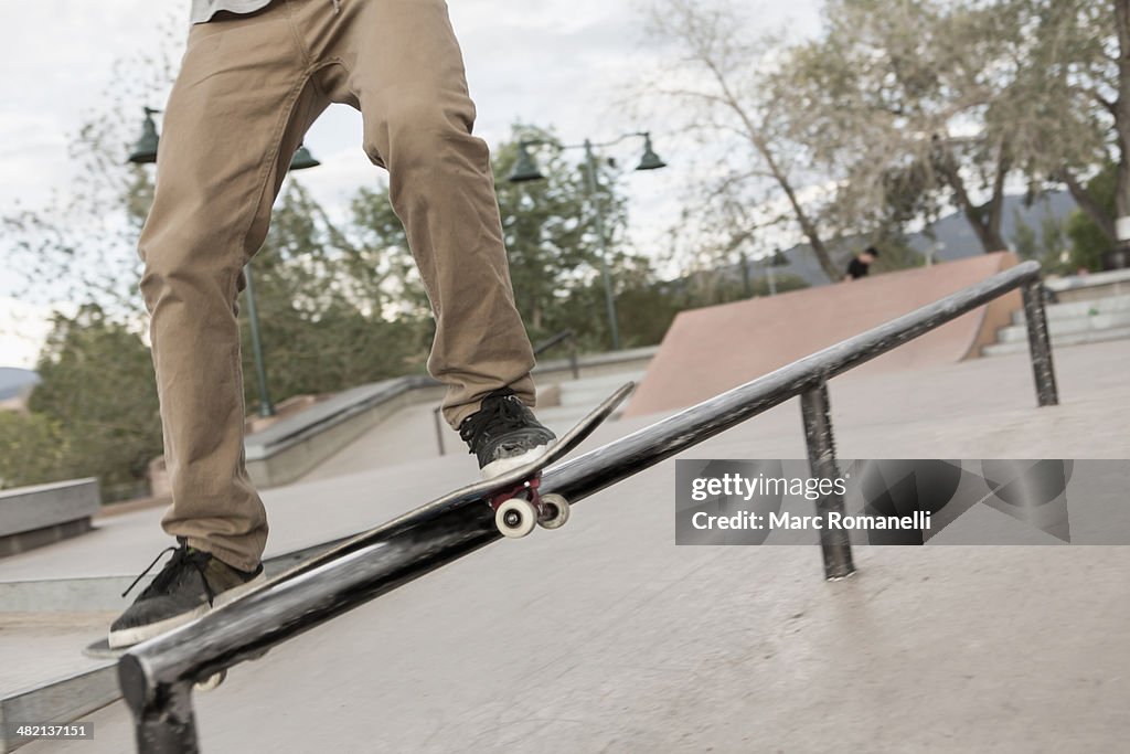 Mixed race boy skateboarding in park