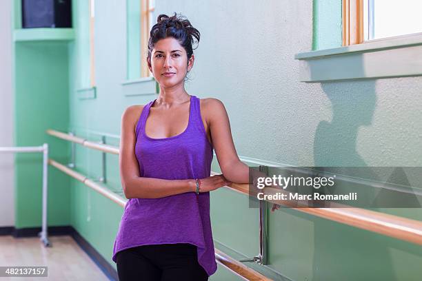 ballet teacher standing at barre in studio - dance teacher foto e immagini stock