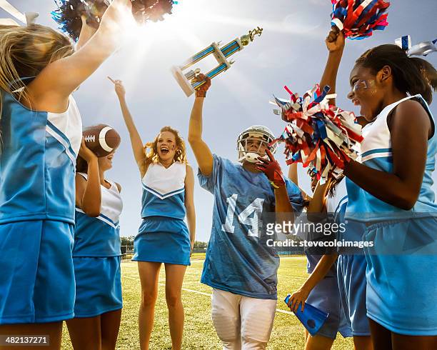 cheerleader & football player - cheerleading stock-fotos und bilder