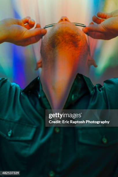 caucasian man looking through glasses - aura fotografías e imágenes de stock