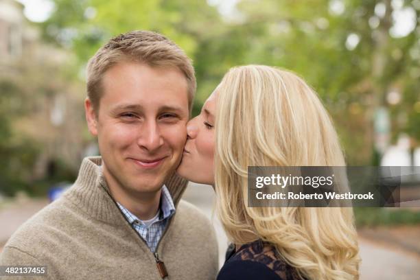 Kissing Women Kissing Mans Cheeks Outdoors Photos and Premium High Res Pictures ...