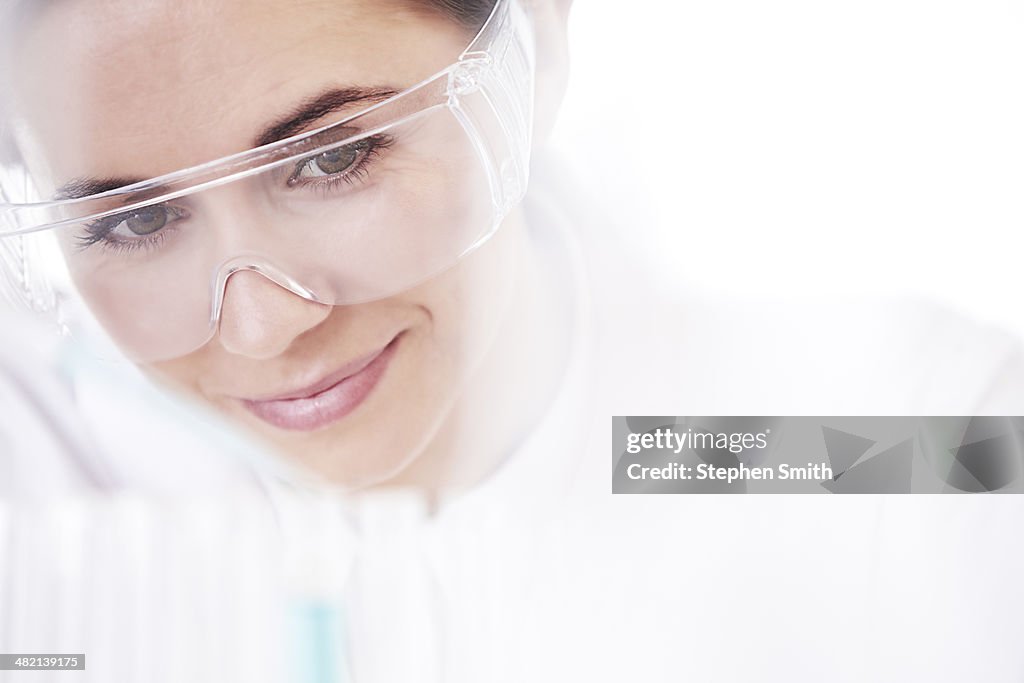 Female lab technician taking test tube samples