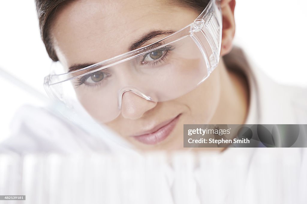 Female lab technician taking test tube samples