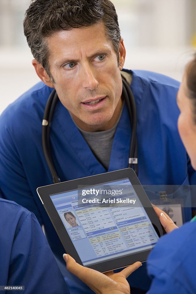 Nurses using digital tablet in hospital