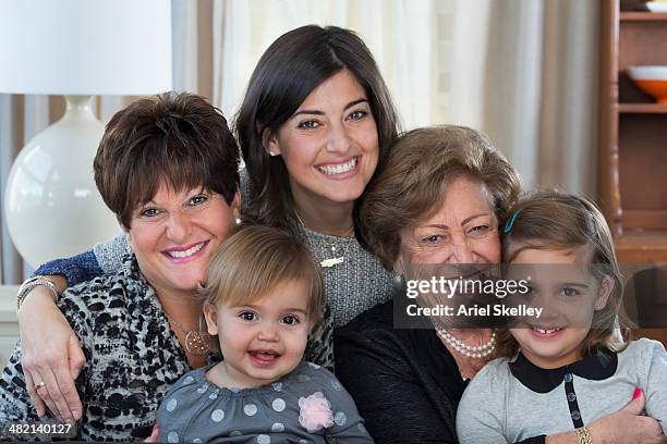 four generations of women smiling together - great grandmother photos et images de collection