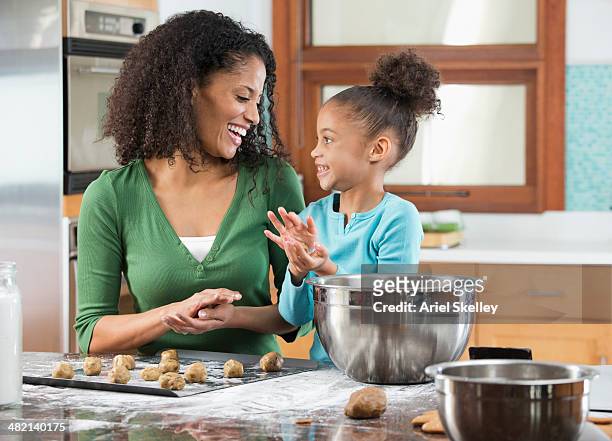 black mother and daughter baking in kitchen - mother daughter baking stock pictures, royalty-free photos & images
