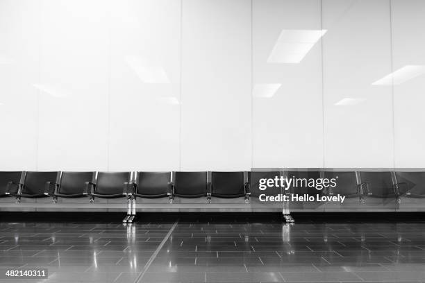 empty seats in airport lobby - flughafen wien stock-fotos und bilder