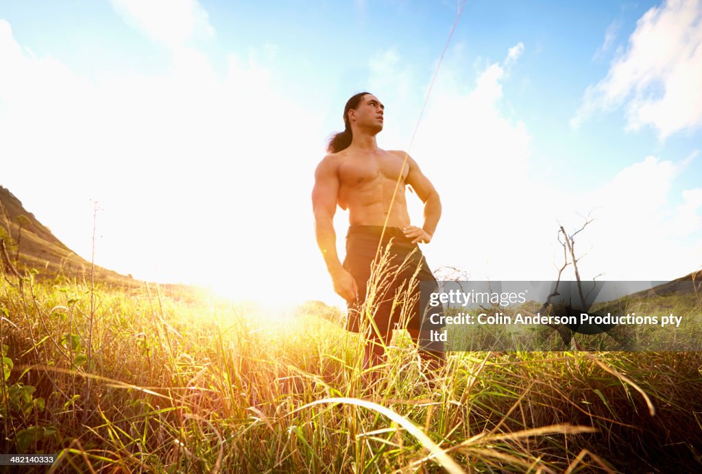 Hawaiian man standing in rural field