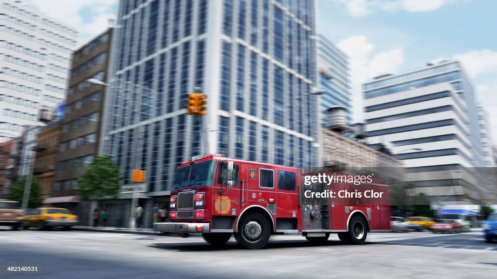 Blurred view of fire truck driving through intersection, New York, New York, United States