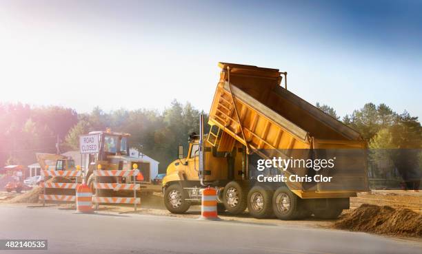 dump truck dumping haul on site - camião basculante imagens e fotografias de stock