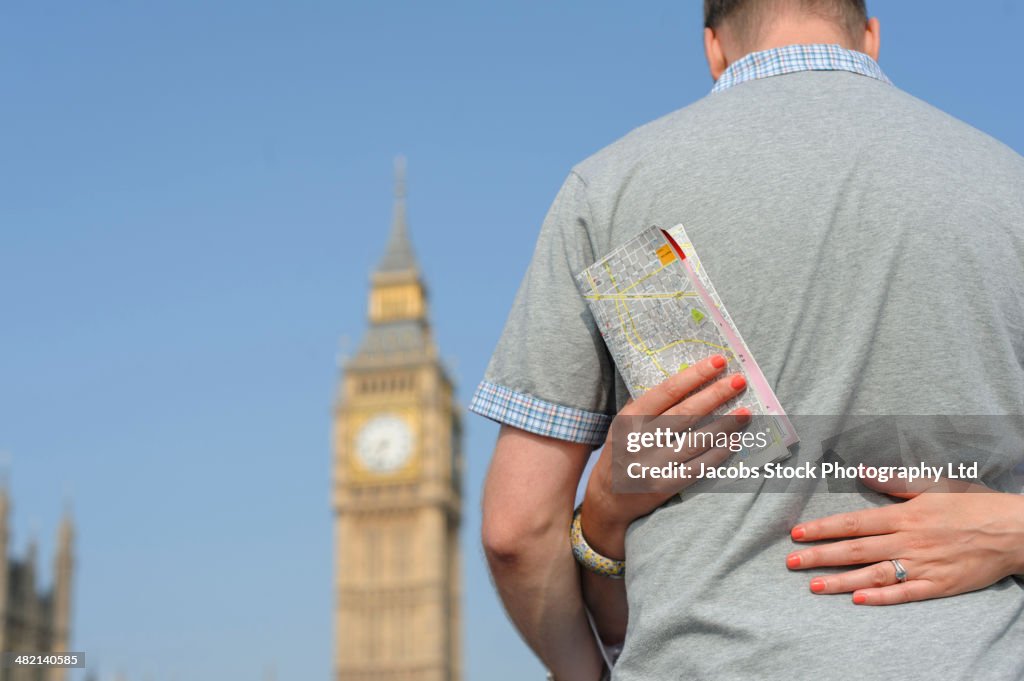 Couple hugging outside Big Ben, London, United Kingdom