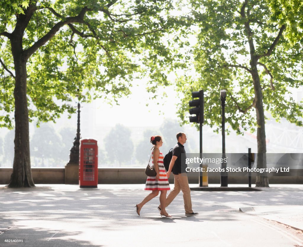 Couple walking together on urban street, London, United Kingdom