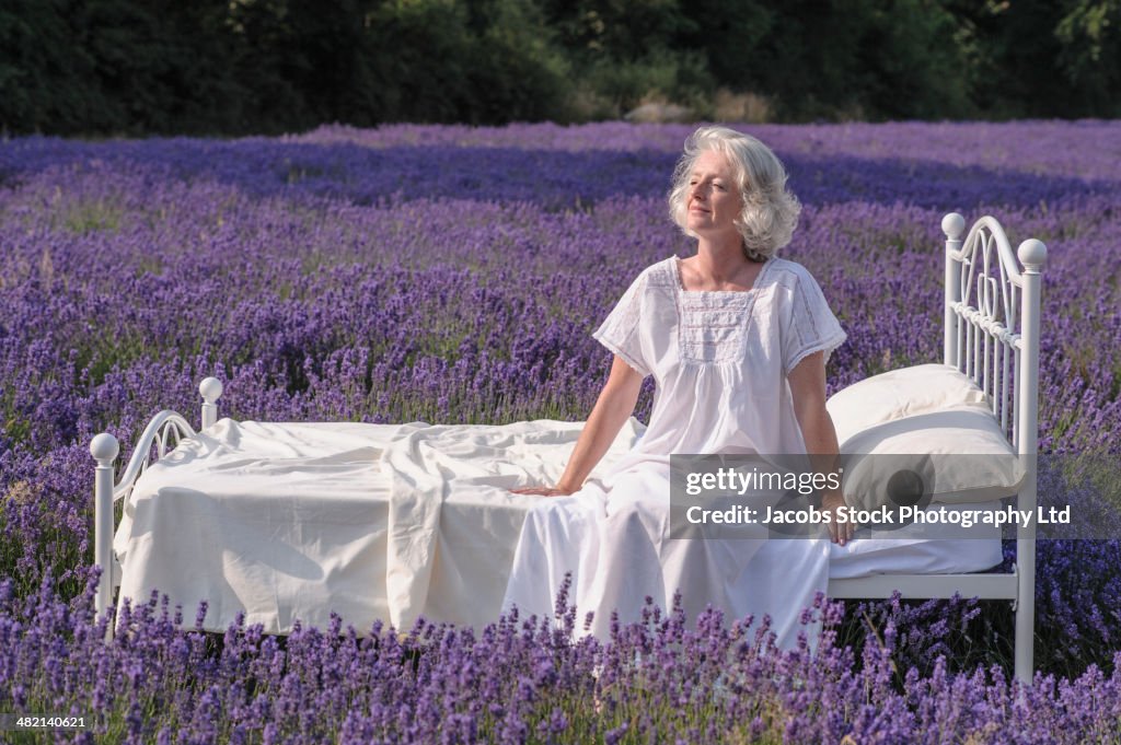 Caucasian woman in bed in lavender field