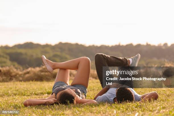 couple laying together in grass - croydon england stock pictures, royalty-free photos & images