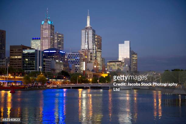 financial district skyline lit up at night, melbourne, victoria, australia - melbourne night stock pictures, royalty-free photos & images
