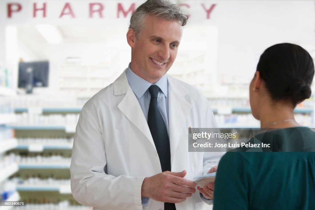 Caucasian pharmacist talking to patient