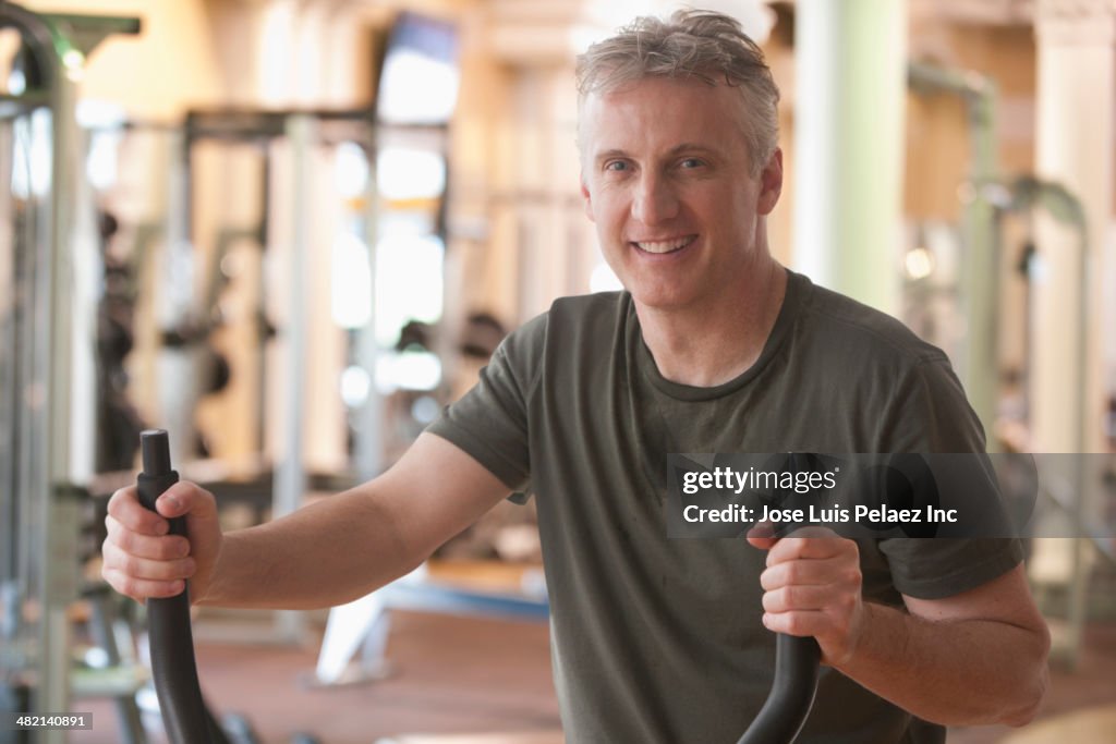 Caucasian man exercising in gym