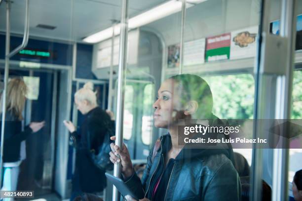 african american woman riding train - west new york new jersey stock-fotos und bilder