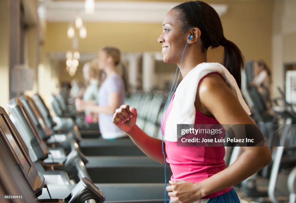 African American woman exercising on treadmill in gym