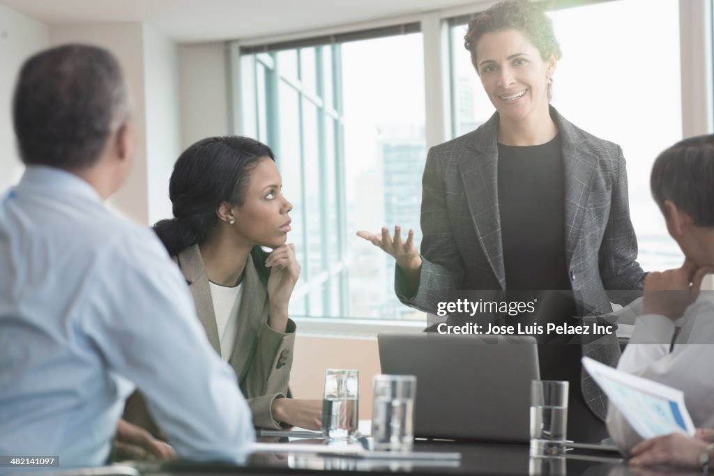 Businesswoman talking to colleagues in meeting