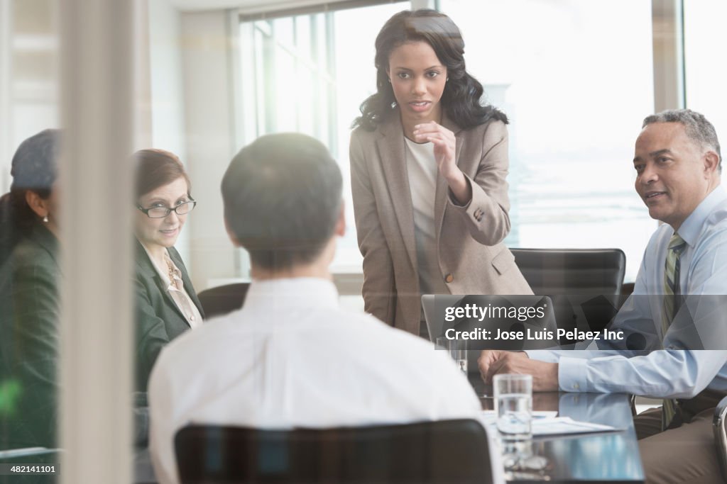 Businesswoman talking to colleagues in meeting