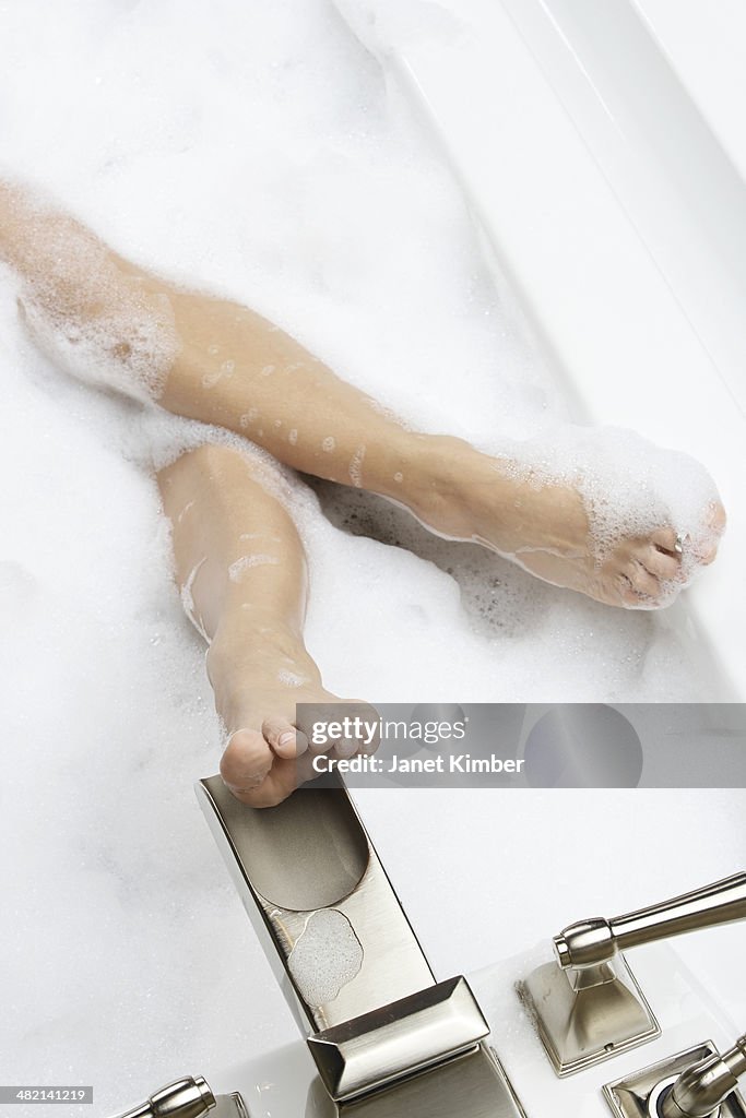 Caucasian woman relaxing in bubble bath