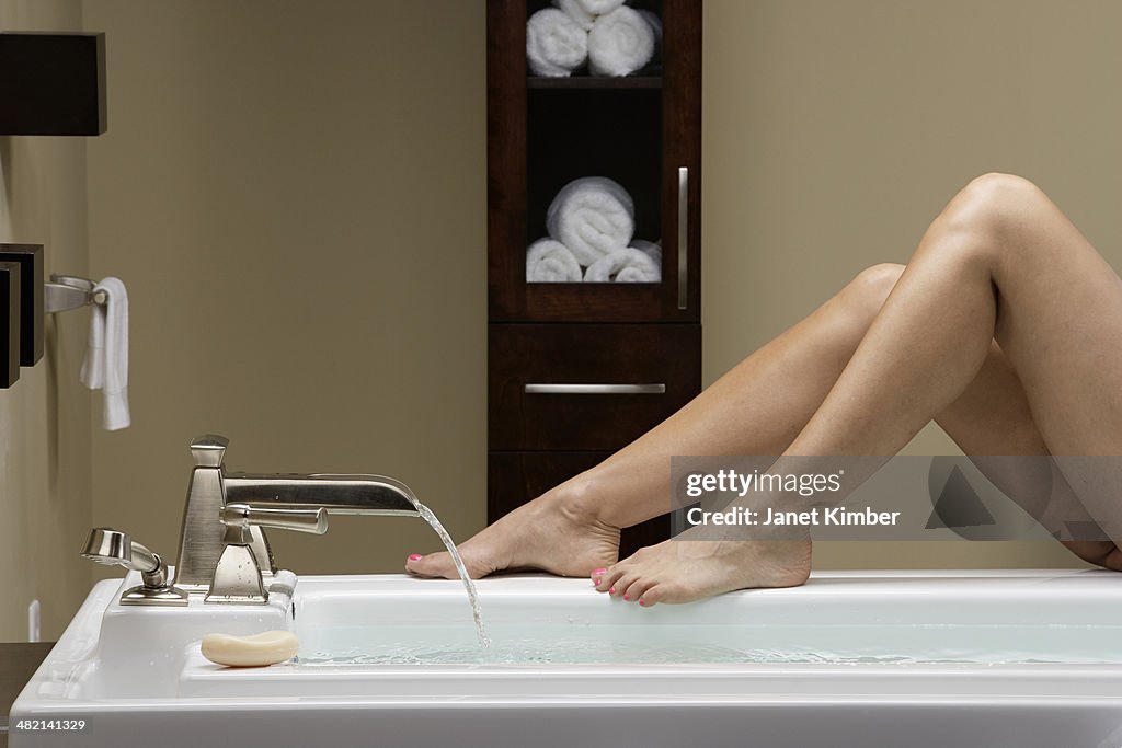 Caucasian woman running bath