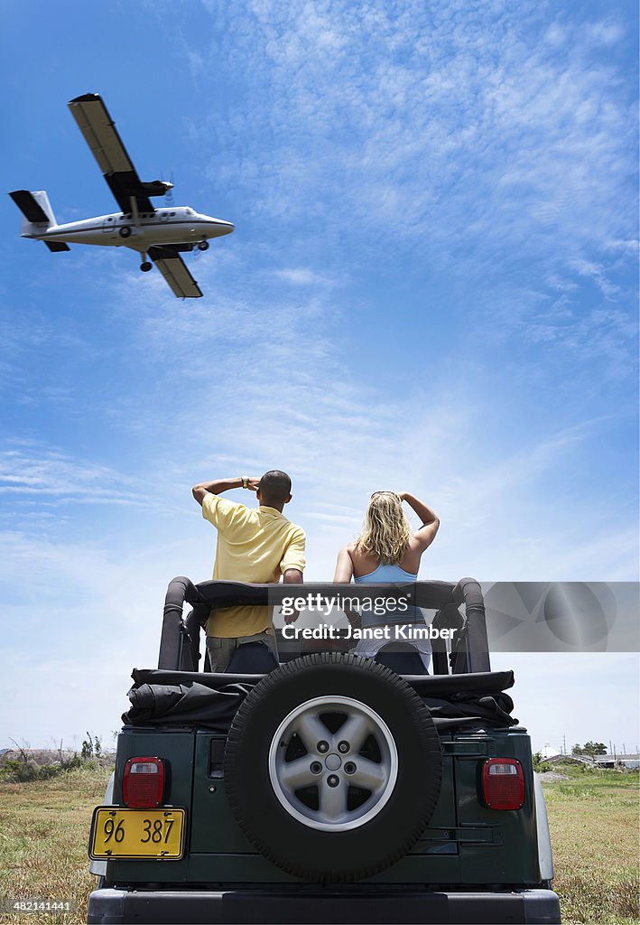 Couple admiring plane from 4x4