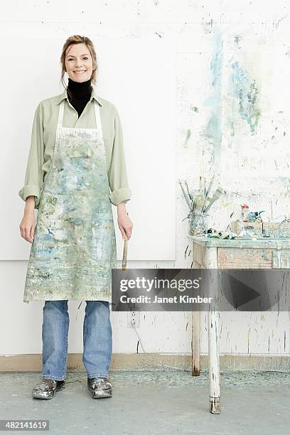caucasian painter smiling in studio - 芸術家 ストックフォトと画像
