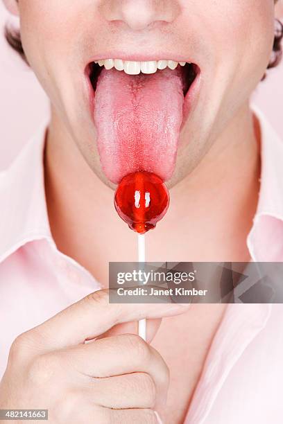 caucasian man licking lollipop - 人間の舌 ストックフォトと画像