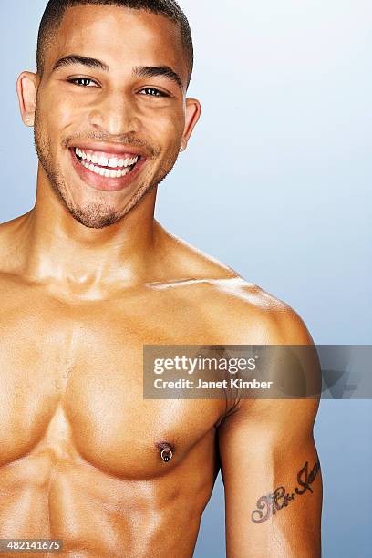 bare chested mixed race man smiling - mixed race man standing studio stockfoto's en -beelden