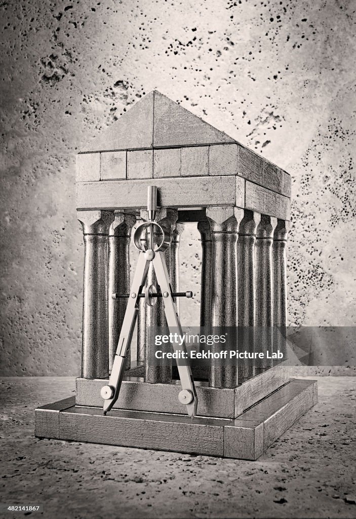 Silver model of pillars and archway with compass