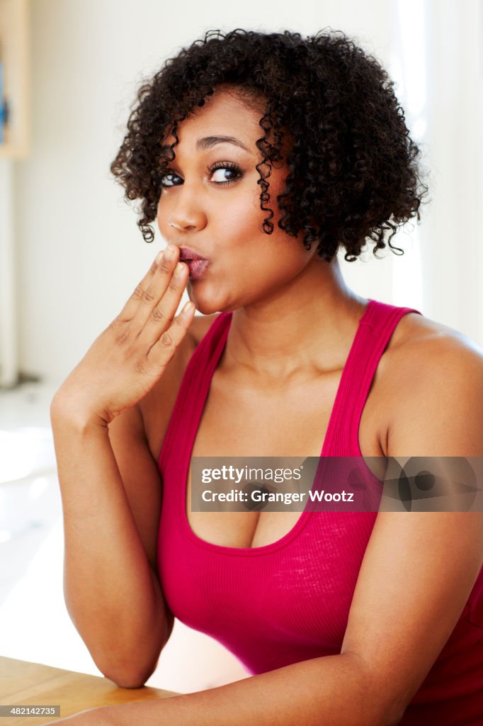Mixed race woman covering her mouth