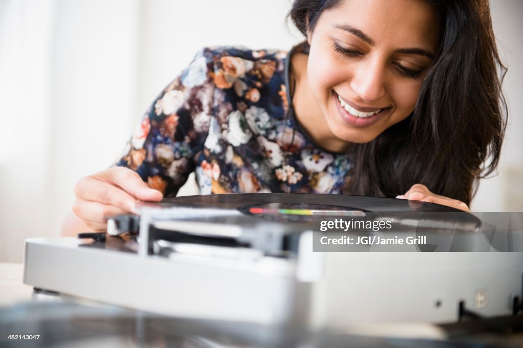 Close up of Asian woman using record player