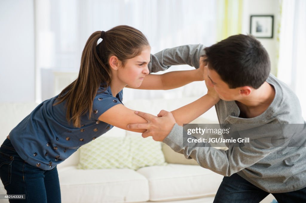 Caucasian brother and sister fighting