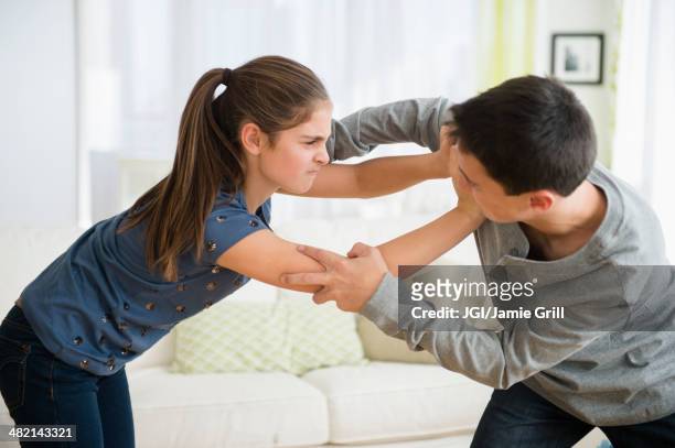 caucasian brother and sister fighting - rough housing stock pictures, royalty-free photos & images