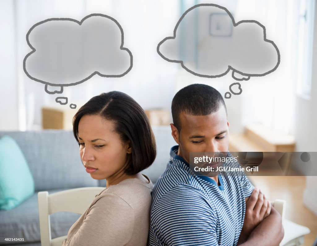 Thought bubbles above frustrated couple