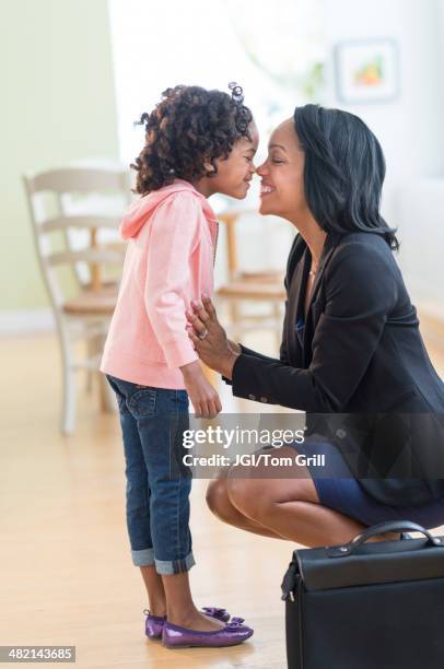 black mother and daughter rubbing noses - nuzzling stockfoto's en -beelden