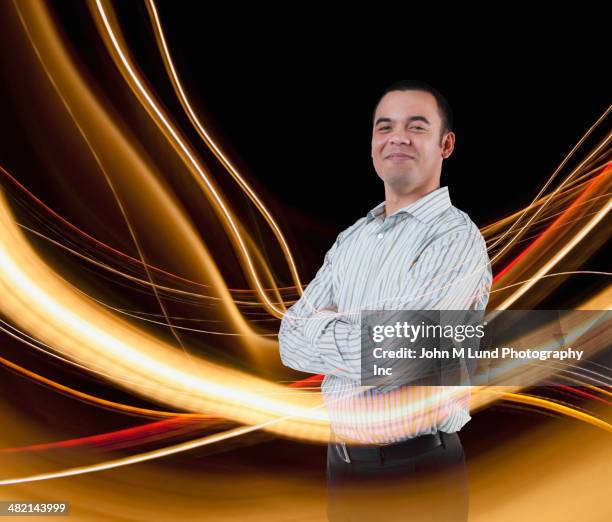 blurred lines around portrait of confident mixed race businessman - mixed race man standing studio stockfoto's en -beelden