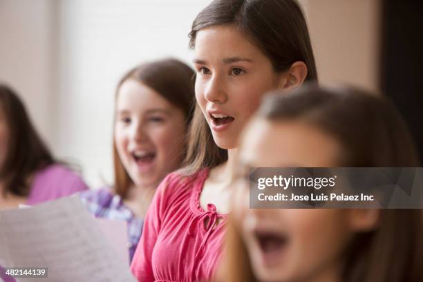 caucasian girls singing in music class - kids singing stock pictures, royalty-free photos & images