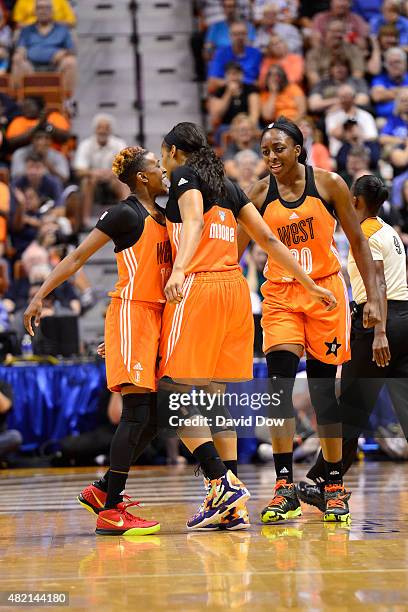 Danielle Robinson of the Western Conference All Stars celebrates a play with Maya Moore and Nneka Ogwumike of the Western Conference All Stars during...