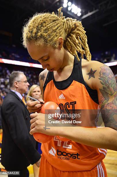 Brittney Griner of the Western Conference All Stars signs autographs after the Boost Mobile WNBA All-Star 2015 Game at the Mohegan Sun Arena on July...