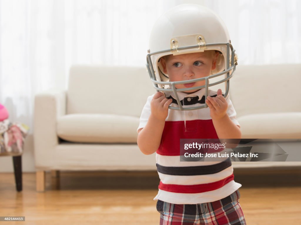 Caucasian boy wearing football helmet