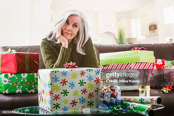 irritated caucasian woman wrapping christmas gifts - christmas stress stock pictures, royalty-free photos & images