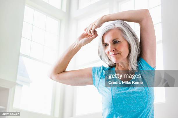 caucasian woman stretching arms - training copy space stockfoto's en -beelden