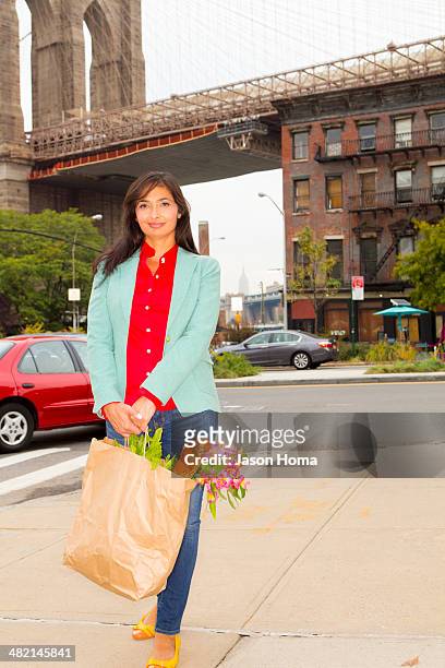 mixed race woman with shopping bag, new york, new york, united states - mature woman full length stock pictures, royalty-free photos & images