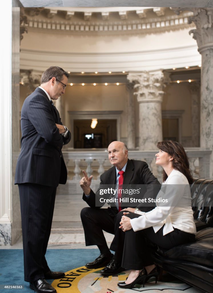 Caucasian politicians talking in government building