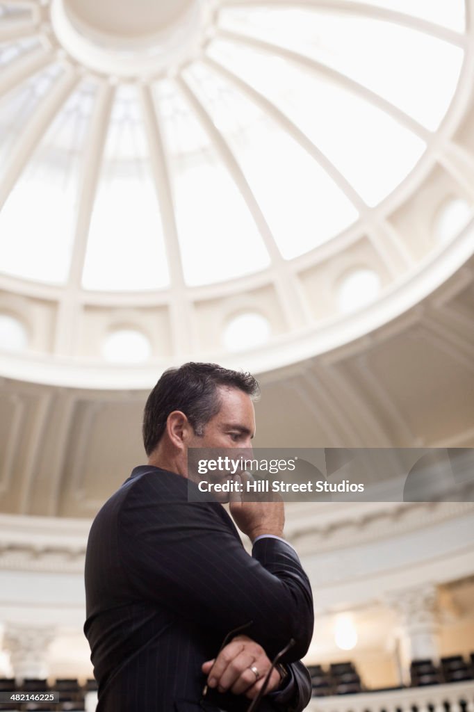 Caucasian politician thinking in government building