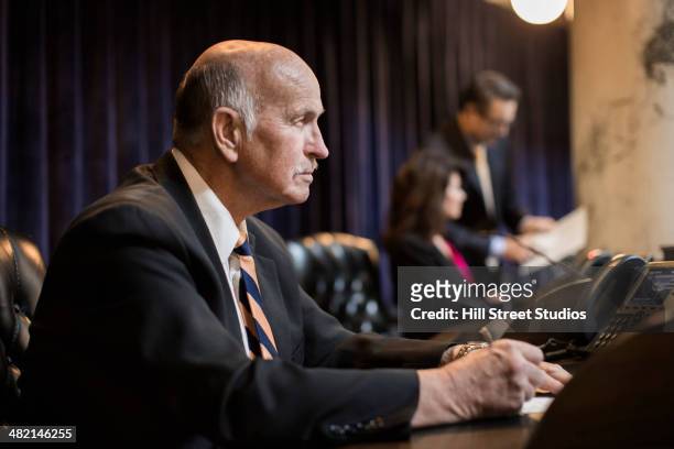 caucasian politician taking notes in chamber - local government official stock pictures, royalty-free photos & images